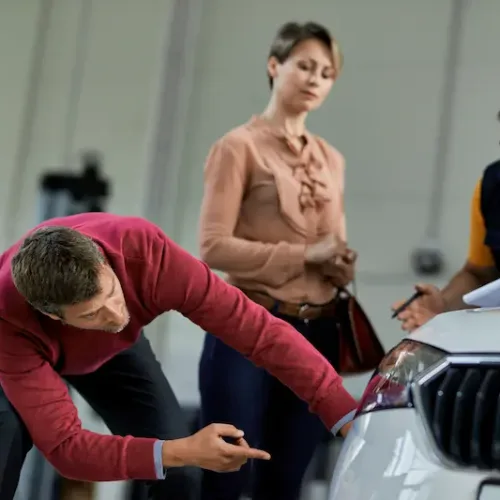 male-customer-examining-his-car-while-being-at-aut-2024-12-13-22-11-26-utc