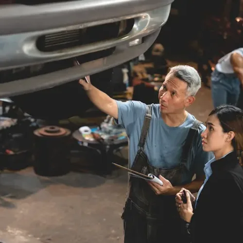 senior-male-mechanic-in-uniform-checking-and-diagn-2025-03-25-18-23-18-utc